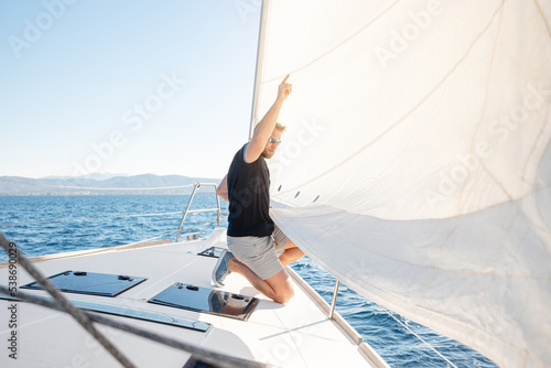 Man setting sail on his boat or yacht photo