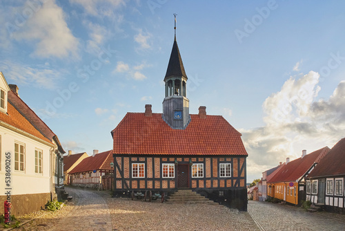 Ebeltoft, Denmark, September, 2022: Ancient chapel on a cozy street at sunset