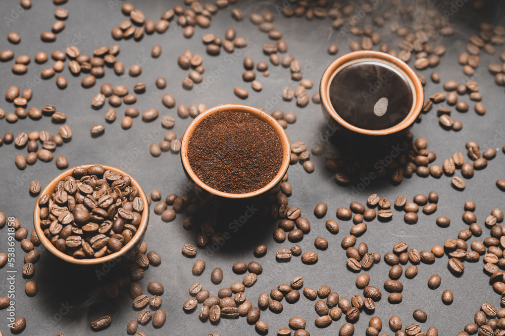 Three cups with different coffee, coffee beans, ground and ready-made drink. Three cups with different coffee, coffee beans, ground and ready-made drink.