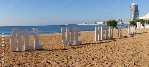 All We Need is Love sign on a Mediterranean beach
