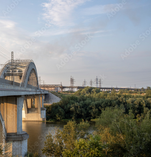 Freight train rides on the railway bridge. Industrial Zone. © Sergei