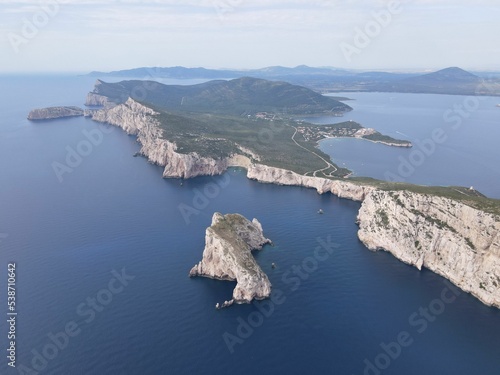 Aerial view of Capo Caccia's vertical cliffs surrounded by the clear blue sea photo