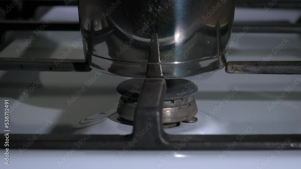 Expensive gas. The man turns off the gas under the coffee pot. The concept of careful attitude to domestic gas. Expensive gas. The man turns off the gas under the coffee pot. The concept of careful attitude to domestic gas.