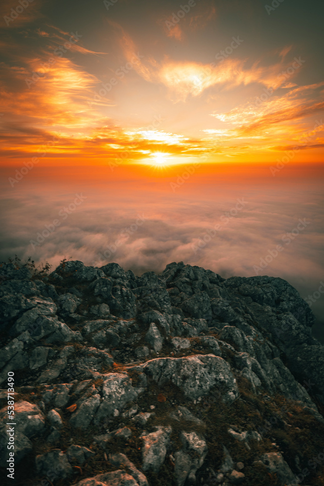 Sunrise on Mountain Top over the Clouds