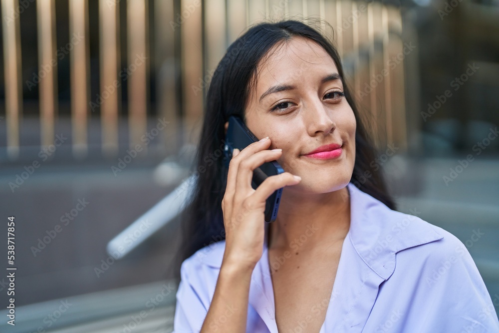 Young beautiful hispanic woman smiling confident talking on the smartphone at street Young beautiful hispanic woman smiling confident talking on the smartphone at street