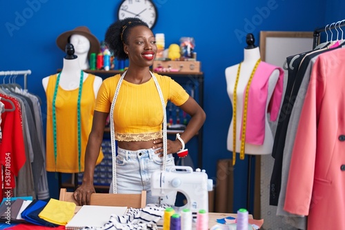 African american woman tailor smiling confident standing at sewing studio