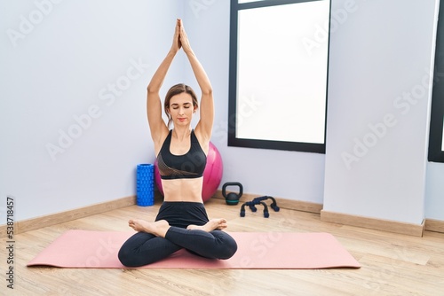 Fototapeta Naklejka Na Ścianę i Meble -  Young woman training yoga at sport center