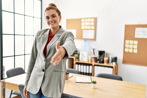 Young woman business worker shak hand at office