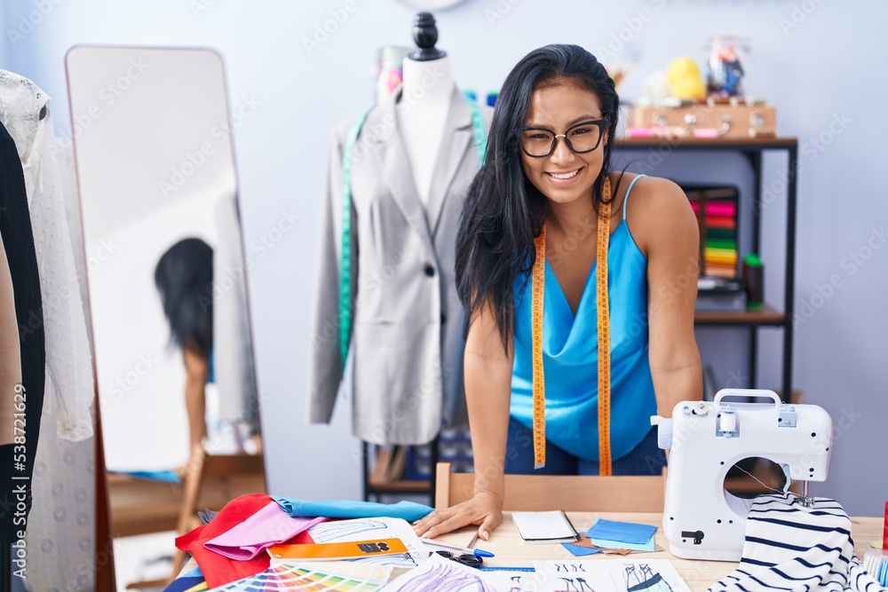 Young beautiful latin woman tailor smiling confident standing at florist Young beautiful latin woman tailor smiling confident standing at florist