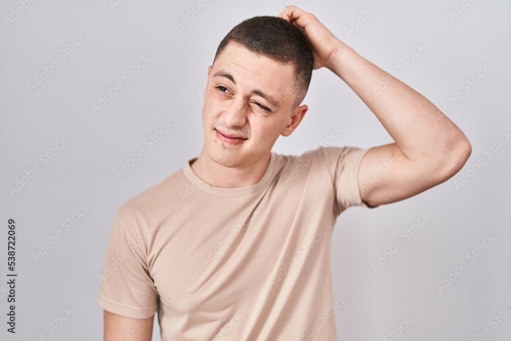 Young man standing over isolated background confuse and wondering about question. uncertain with doubt, thinking with hand on head. pensive concept. Young man standing over isolated background confuse and wondering about question. uncertain with doubt, thinking with hand on head. pensive concept.