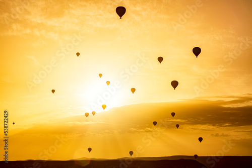 Silhouettes of hot air balloons at sunset sky. Goreme National Park in Cappadocia, Turkey.