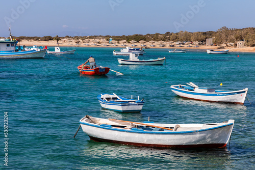 Colorful boats in blue water on Amorgos, Greek Islands