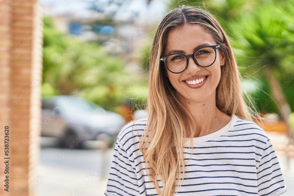 Young blonde woman smiling confident wearing glasses at street Young blonde woman smiling confident wearing glasses at street