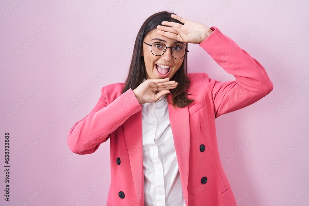 Young hispanic woman wearing business clothes and glasses smiling cheerful playing peek a boo with hands showing face. surprised and exited Young hispanic woman wearing business clothes and glasses smiling cheerful playing peek a boo with hands showing face. surprised and exited
