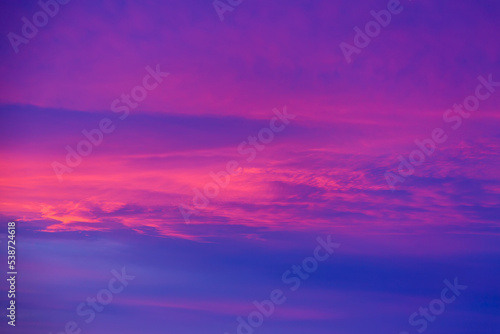 Vivid saturated beautiful sunset sky in pink, purple and blue colors. Abstract amazing sunset background