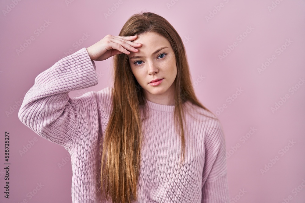 Young caucasian woman standing over pink background worried and stressed about a problem with hand on forehead, nervous and anxious for crisis Young caucasian woman standing over pink background worried and stressed about a problem with hand on forehead, nervous and anxious for crisis