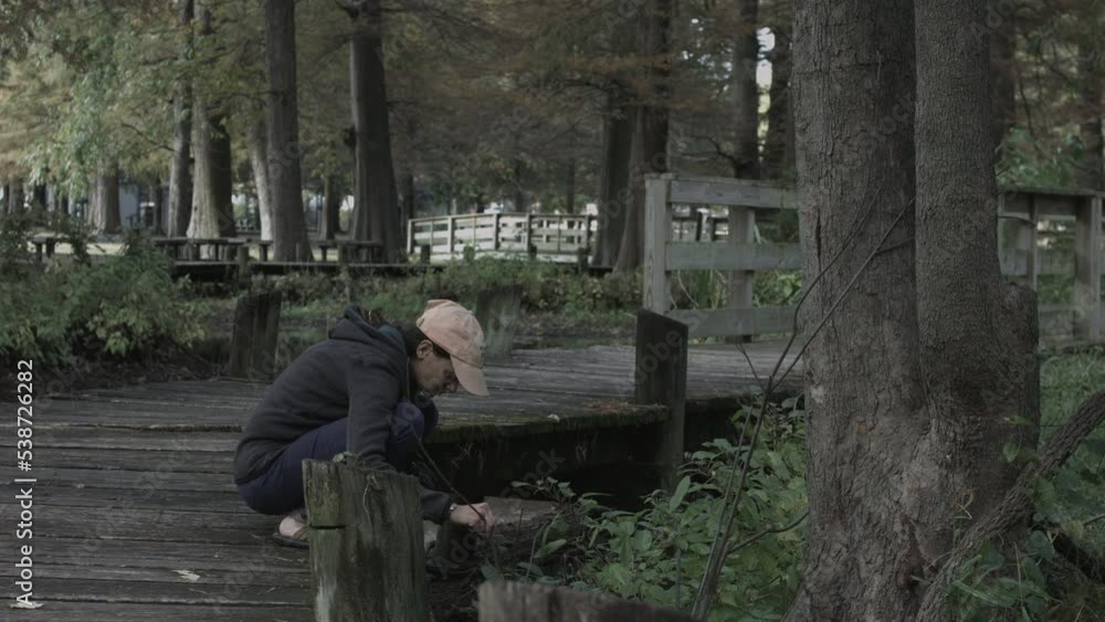 Young Woman Enjoys Nature Photography at Reelfoot Lake State Park 4K Young Woman Enjoys Nature Photography at Reelfoot Lake State Park 4K