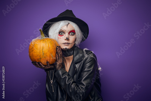Scared surprised witch with grey hair on Halloween