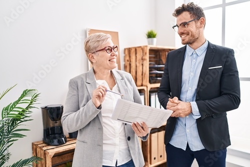 Mother and son business workers reading document at office