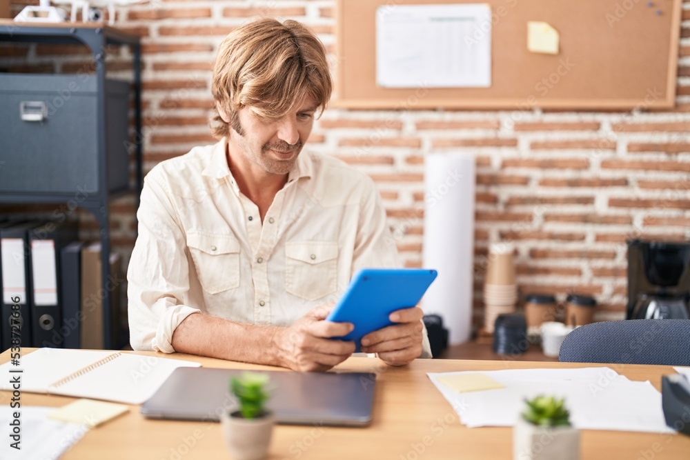 Young man business worker using touchpad at office Young man business worker using touchpad at office