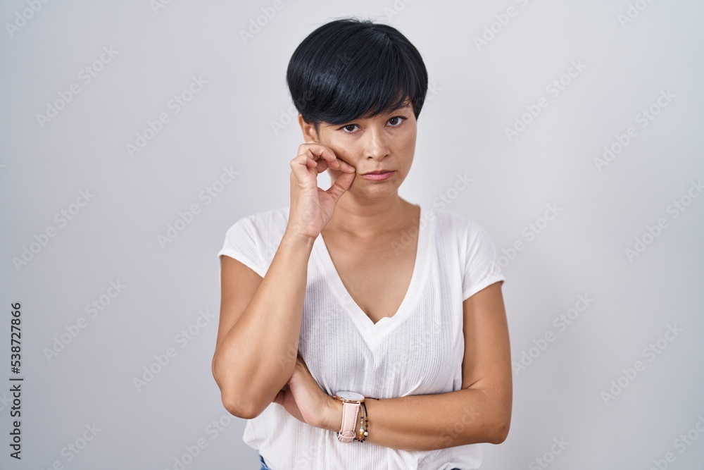 Young asian woman with short hair standing over isolated background mouth and lips shut as zip with fingers. secret and silent, taboo talking Young asian woman with short hair standing over isolated background mouth and lips shut as zip with fingers. secret and silent, taboo talking
