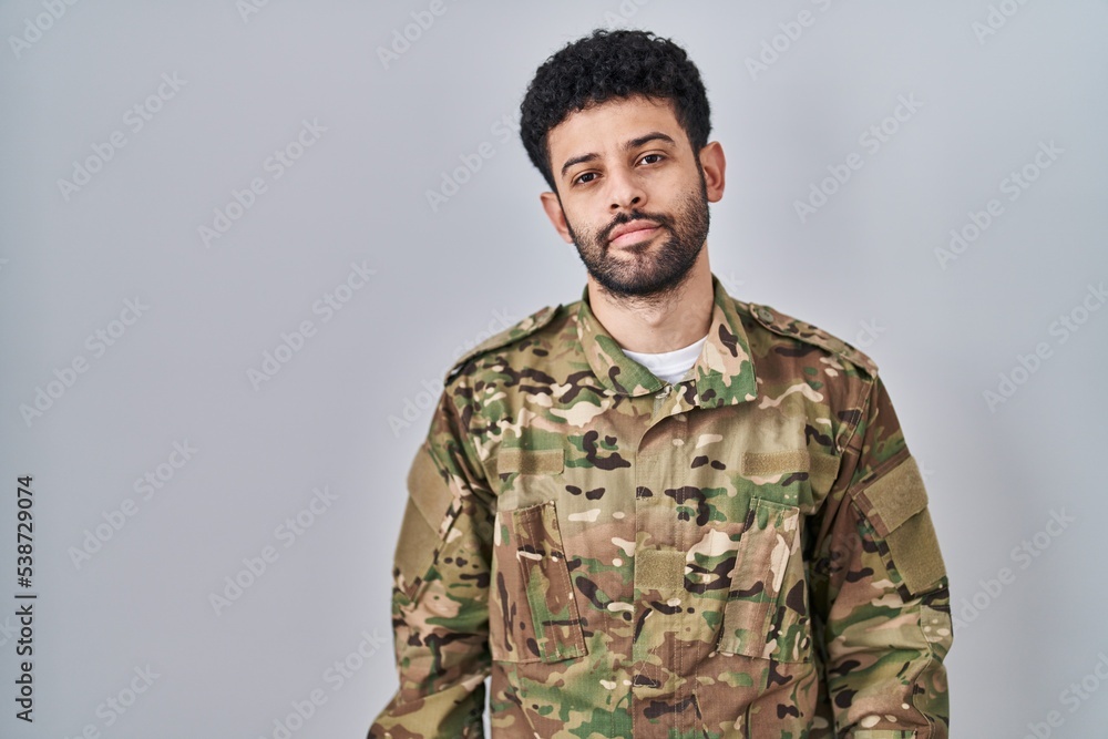 Arab man wearing camouflage army uniform looking sleepy and tired, exhausted for fatigue and hangover, lazy eyes in the morning. Arab man wearing camouflage army uniform looking sleepy and tired, exhausted for fatigue and hangover, lazy eyes in the morning.