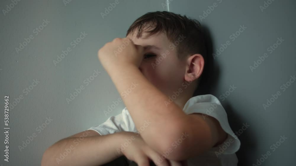 Domestic violence concept. Child abuse. Portrait of a Cute boy with big tears running down his cheeks, Sad upset boy sitting in corner lifestyle.Child punished sitting crying in the corner. Domestic violence concept. Child abuse. Portrait of a Cute boy with big tears running down his cheeks, Sad upset boy sitting in corner lifestyle.Child punished sitting crying in the corner.