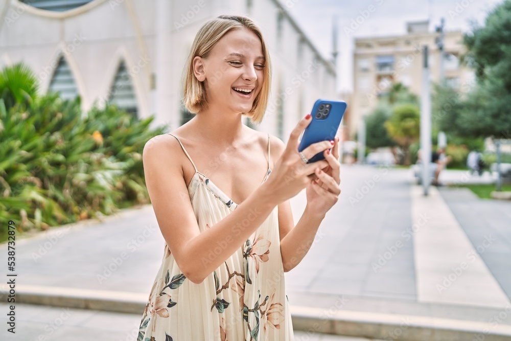 Young beautiful woman using smartphone outdoor