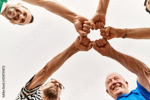 Group of middle age friends with fists together.