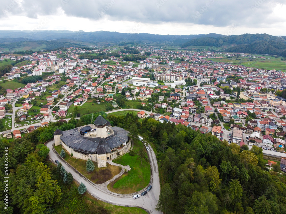 Velika Kladusa, Bosnia and Herzegovina, aerial drone view. Buildings, streets and residential houses. Velika Kladuša is a town and municipality in western BiH. Castle and medieval walls on hill.