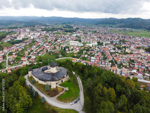 Velika Kladusa, Bosnia and Herzegovina, aerial drone view. Buildings, streets and residential houses. Velika Kladuša is a town and municipality in western BiH. Castle and medieval walls on hill.