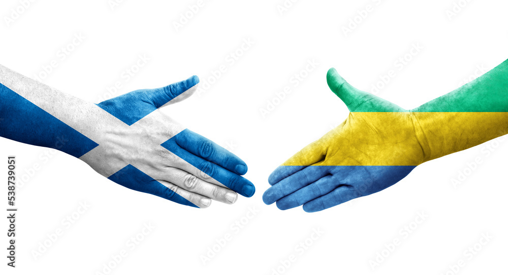 Handshake between Gabon and Scotland flags painted on hands, isolated transparent image. Handshake between Gabon and Scotland flags painted on hands, isolated transparent image.