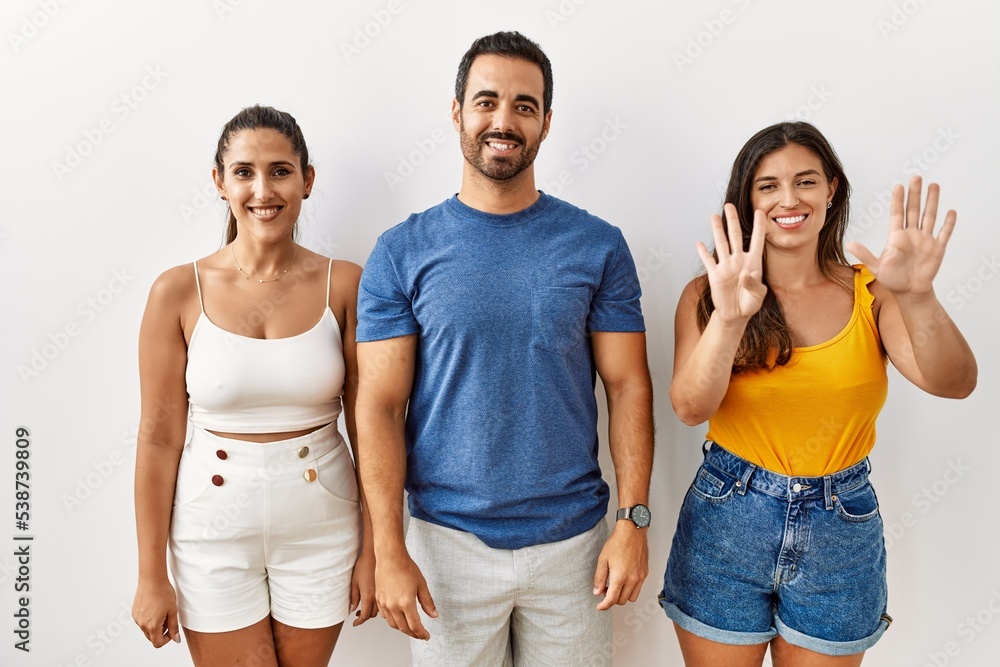 Group of young hispanic people standing over isolated background showing and pointing up with fingers number nine while smiling confident and happy. Group of young hispanic people standing over isolated background showing and pointing up with fingers number nine while smiling confident and happy.