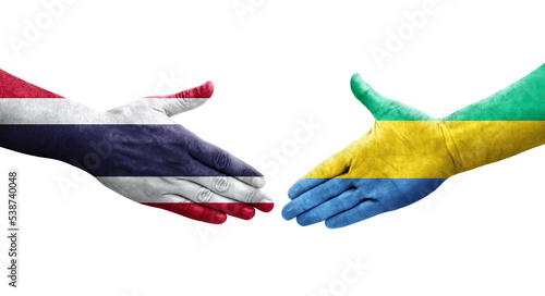 Handshake between Gabon and Thailand flags painted on hands, isolated transparent image.