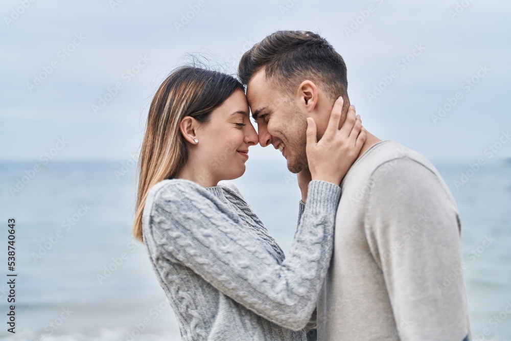 Man and woman couple smiling confident hugging each other at seaside Man and woman couple smiling confident hugging each other at seaside
