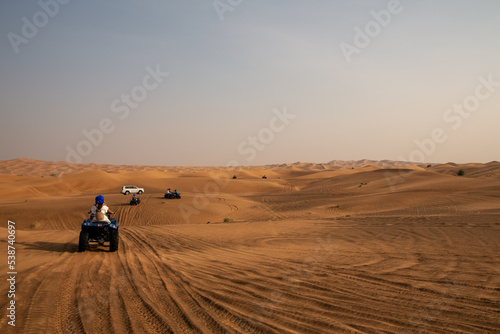 quad bike in sand dunes of desert
