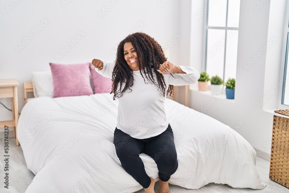 African american woman waking up stretching arms at bedroom African american woman waking up stretching arms at bedroom