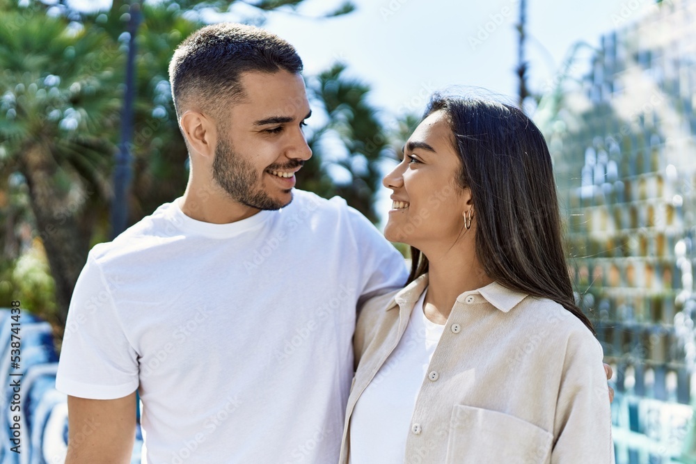 Young latin couple smiling happy and hugging at the city. Young latin couple smiling happy and hugging at the city.