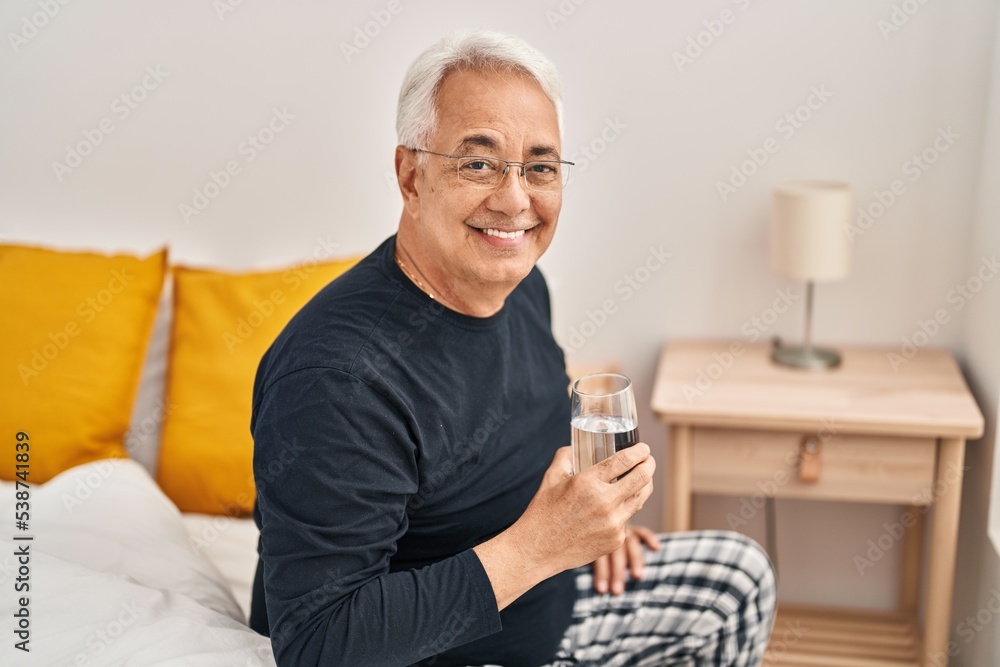 Senior man drinking glass of water at bedroom Senior man drinking glass of water at bedroom