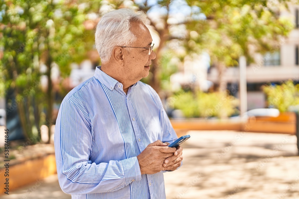 Senior man using smartphone at park Senior man using smartphone at park