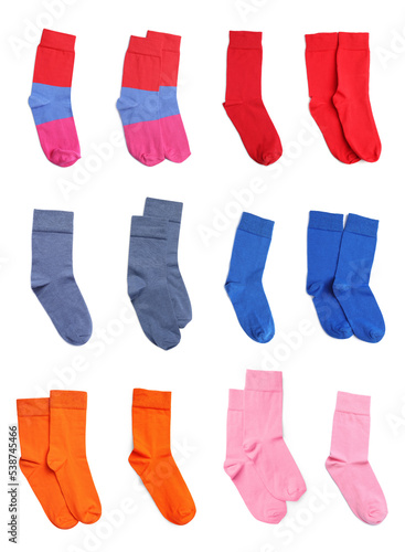 Set with pairs of different color socks on white background, top view