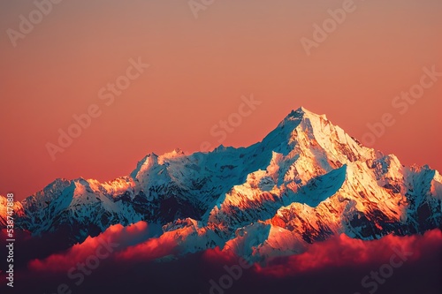 A mountain peak in the rays of the setting sun. Mountain peak snow in evening light. Mountain peak at sunset. Mountain scene photo