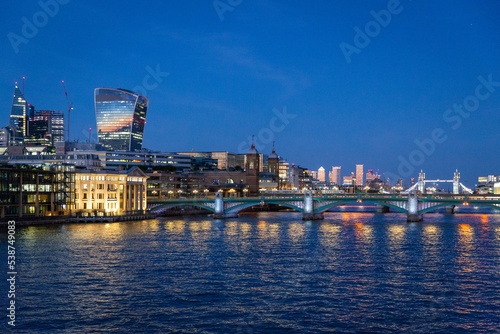 london skyline at sunset along the thames river