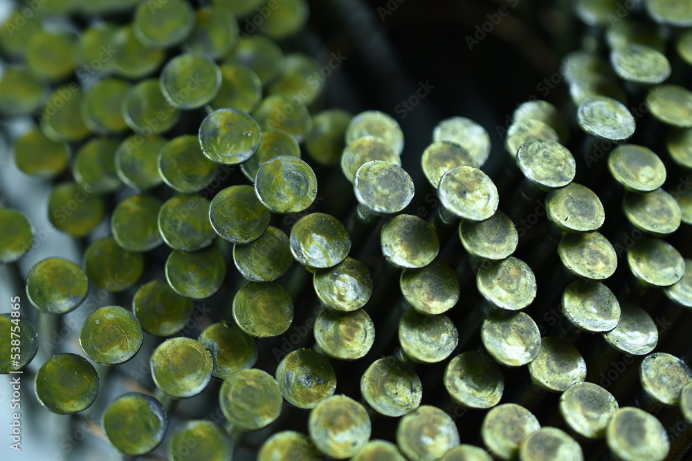 Drum nails twisted into a spiral close-up. Drum nails twisted into a spiral close-up.