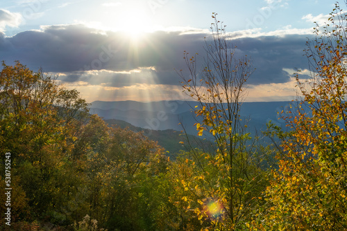 Rays of sunlight break through thick clouds over Blue Ridge Mountains near Shenandoah National Park as seen from Skyline Drive in Virginia.
