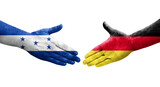 Handshake between Germany and Honduras flags painted on hands, isolated transparent image.