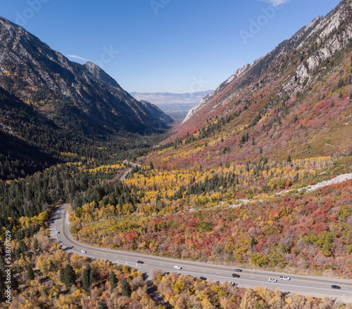 Little Cottonwood Canyon Utah, in Autumn, with the road and cars below. Aerial.