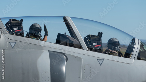 pilotos de un avion de entrenamiento saludan a camara previo al despegue para un vuelo de exhibicion aerea photo