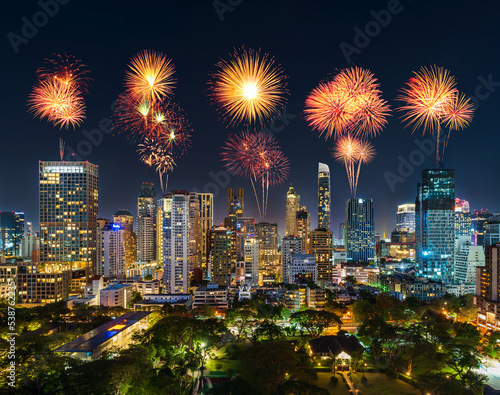 happy new year fireworks over buildings near Witthayu road at night in Bangkok city, Thailand.