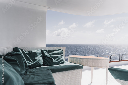 Фотография View from the upper deck of a luxurious diving safari yacht with a wicker table